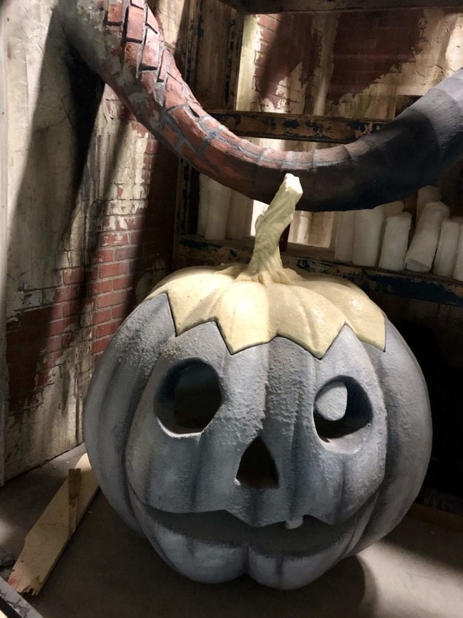 Otherworld's haunted house has Jack-o-lanterns and graves.