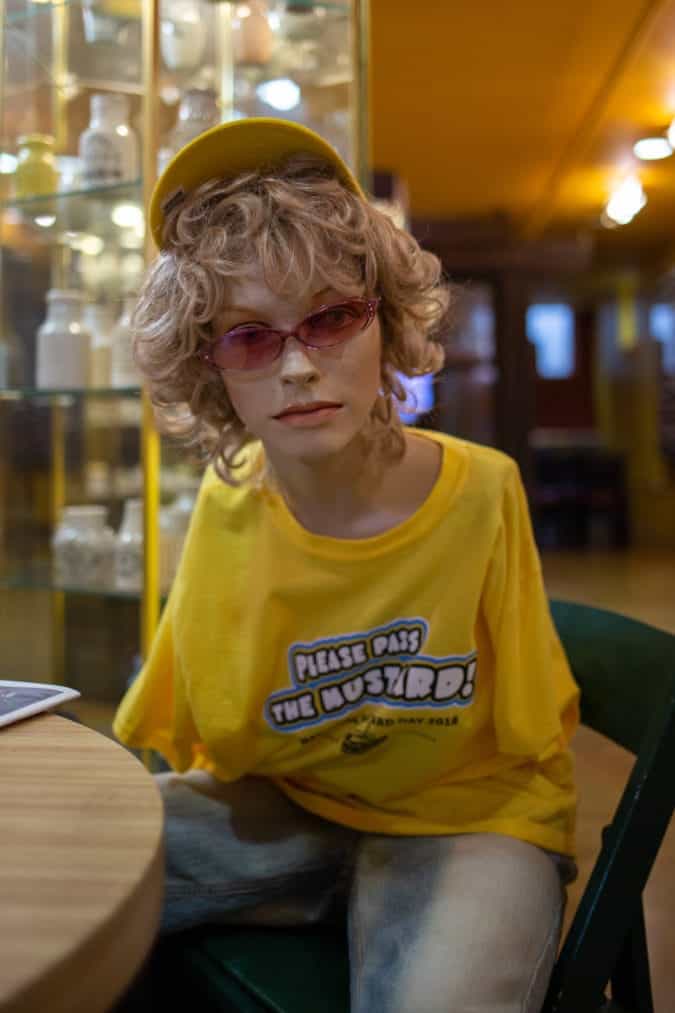 A mannequin wearing a yellow shirt