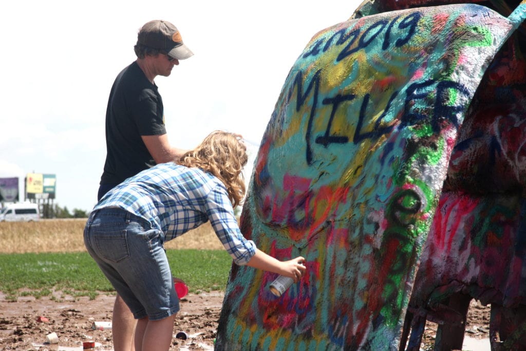 Visitors leave their mark on the old cars