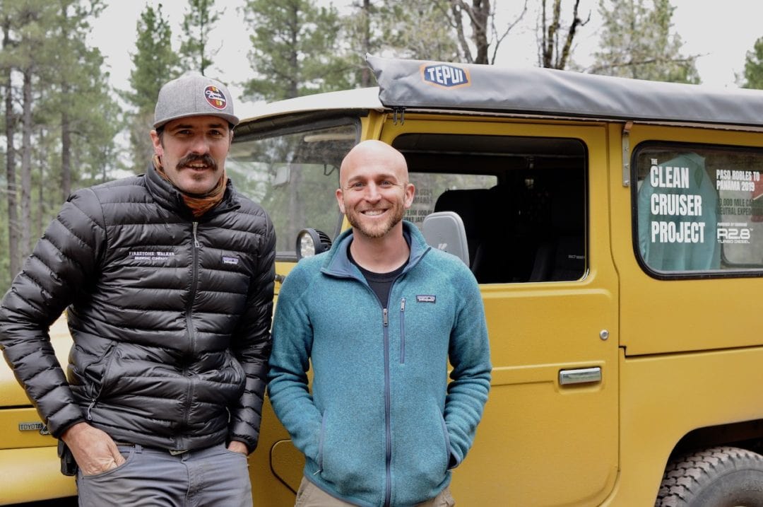 Nathan Stuart and Steve Ploog stand in front of a yellow 4x4