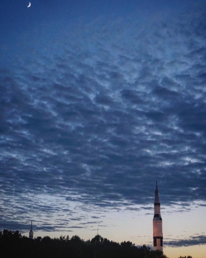 the saturn v peeks out from over the treetops in alabama