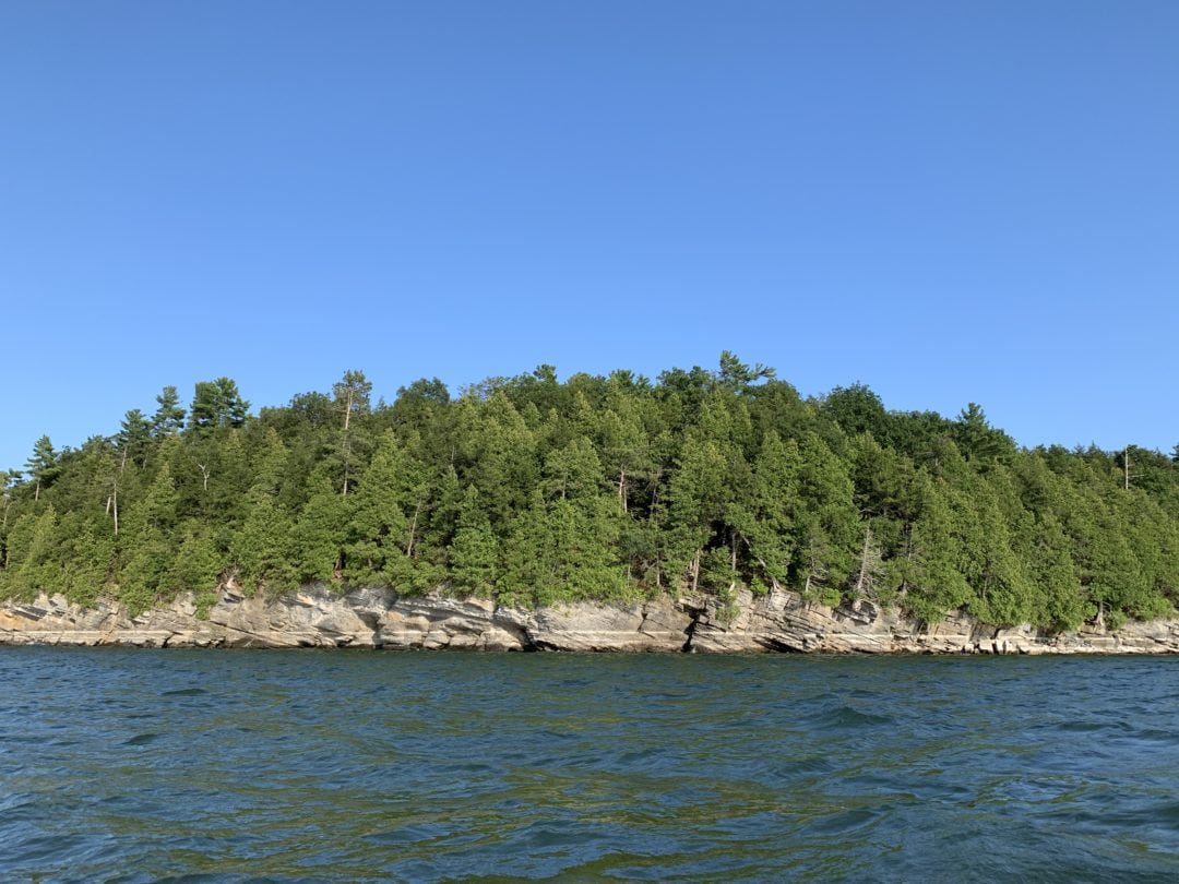 Craggy shores of Vermont dipping into the glacial waters of Lake Champlain