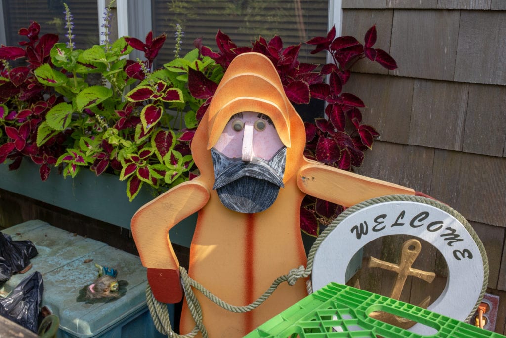 fisherman statue with googly eyes