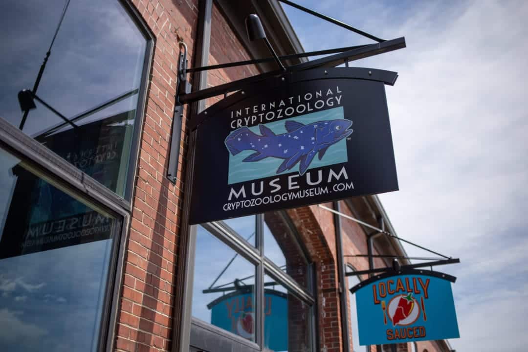 sign for the cryptozoology museum on a brick building