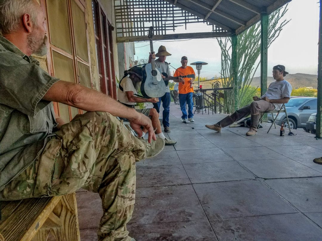 A group of men having a jam session on a porch