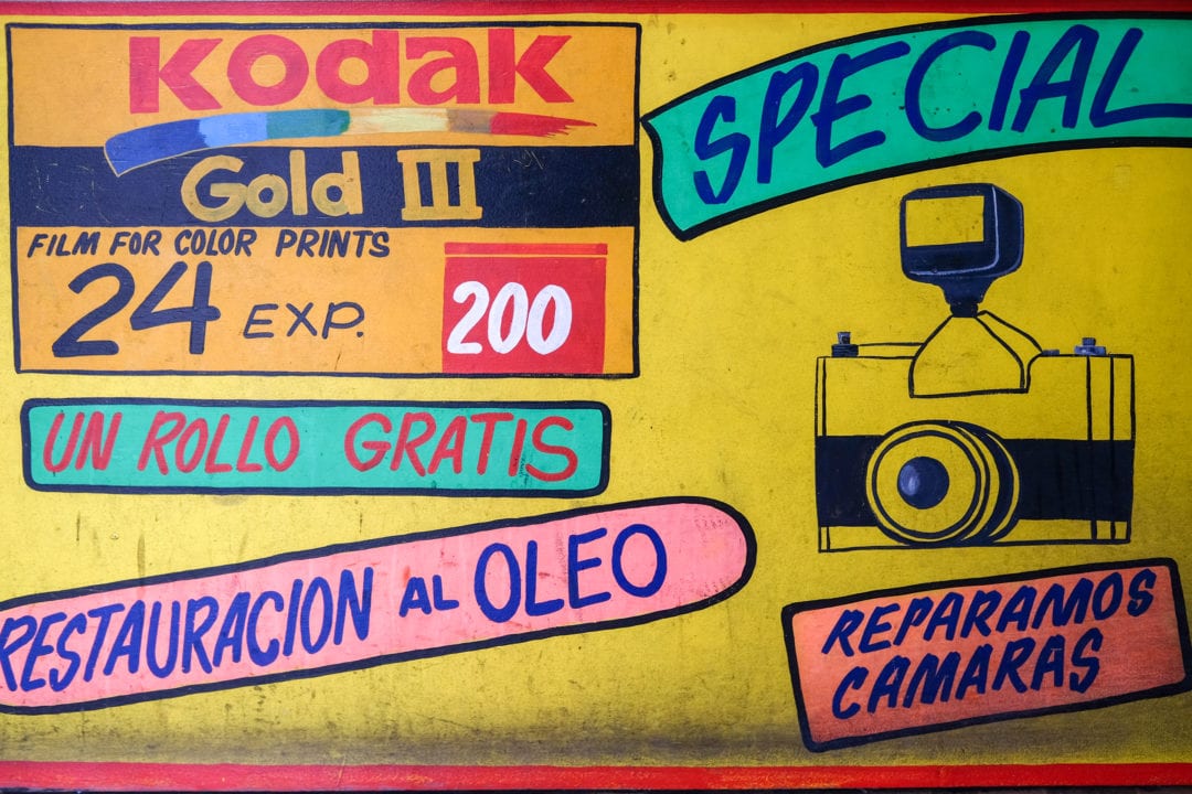 The studio still advertises camera repairs and free rolls of film.