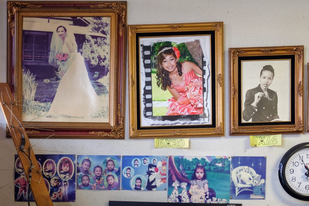 Examples of different photo sizes and styles offered at the shop.