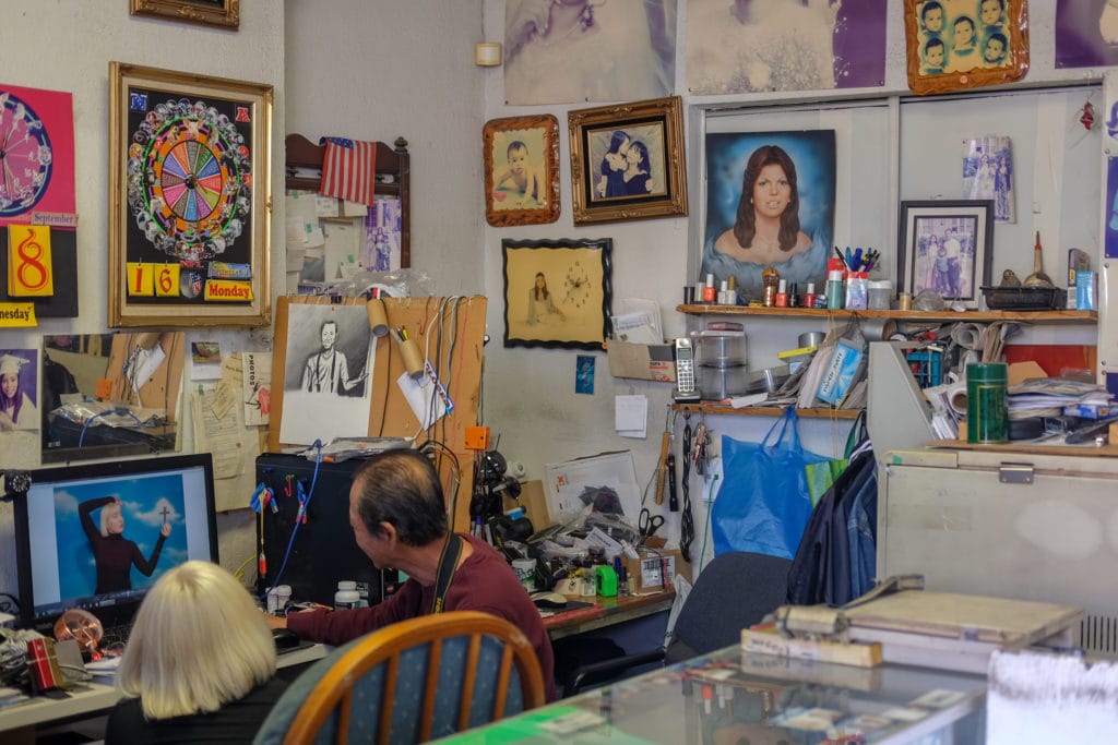 Tom looks over photos with a customer.