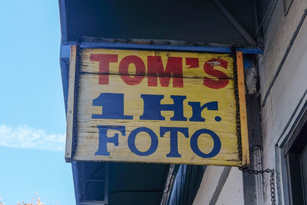 A weathered sign outside the shop.