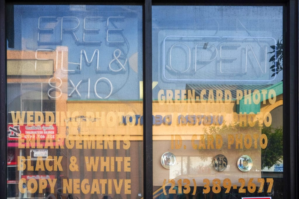 Old signage promises everything from wedding to green card photos.