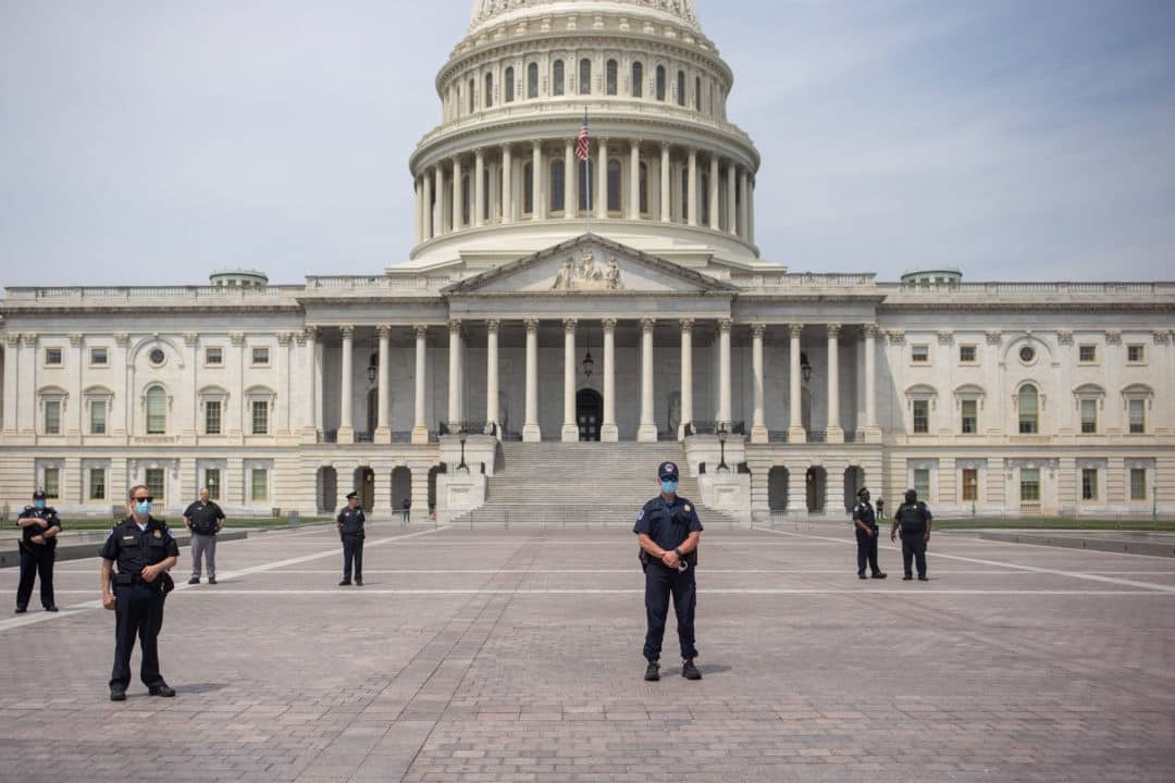 Crowds are kept away from the Capitol by Capitol Police, many of whom wore face masks.