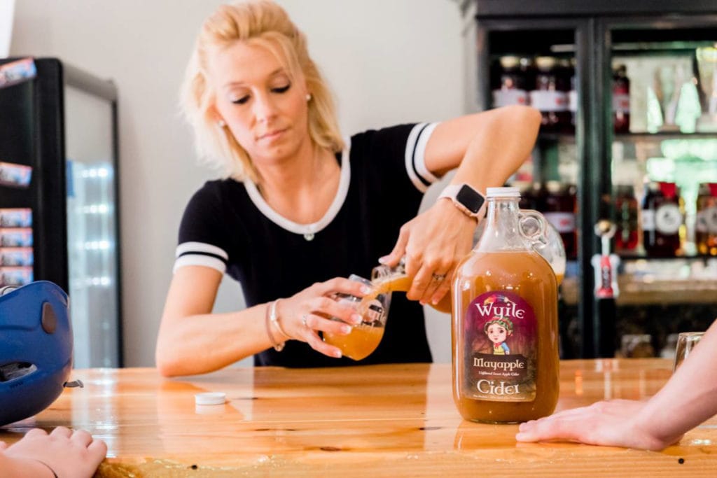 Foxfire Mountain General Manager Tenisha Krouse pours a glass of Wyiles Cider
