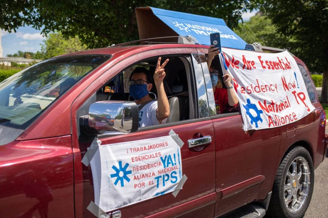 A driver flashes a peace sign.