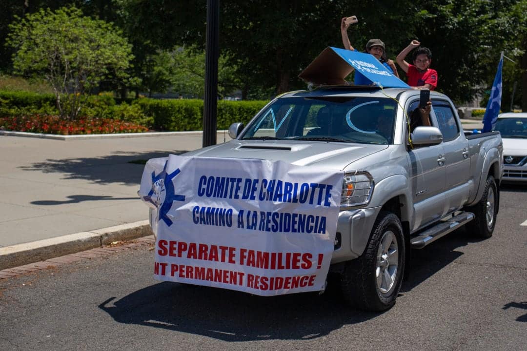 A family pops out of their sunroof.