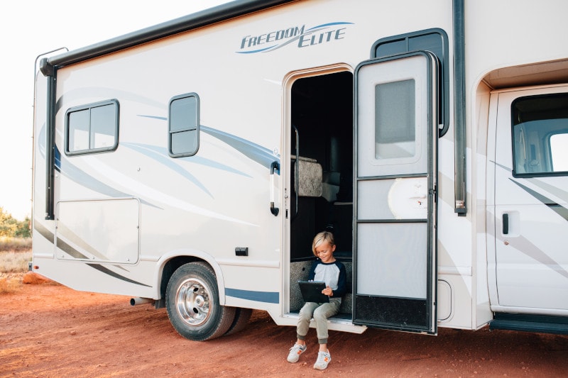 child sitting open rv door