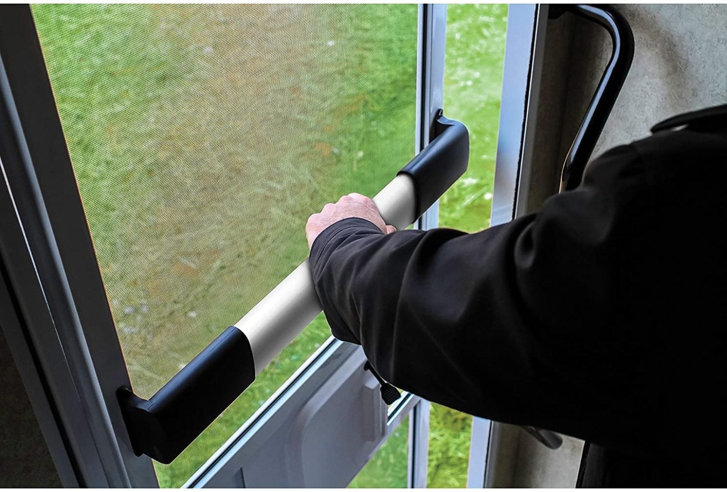Man opening screen door of RV