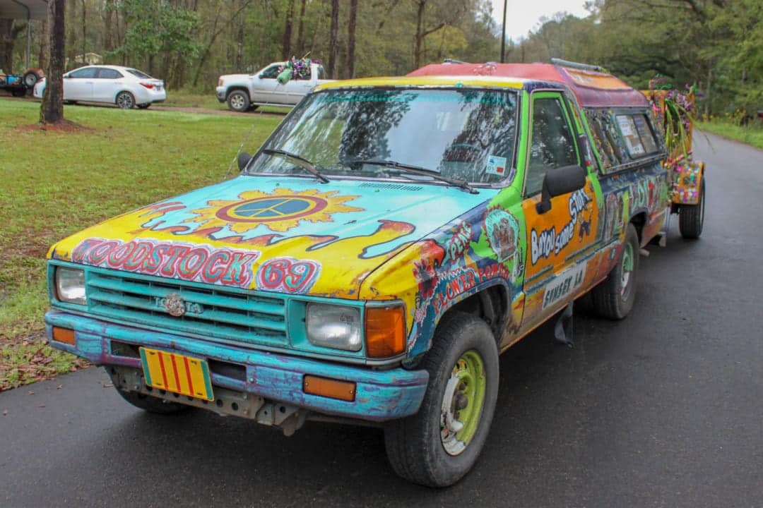 A brightly painted truck is one of the vehicles that make up the Mardi Gras procession
