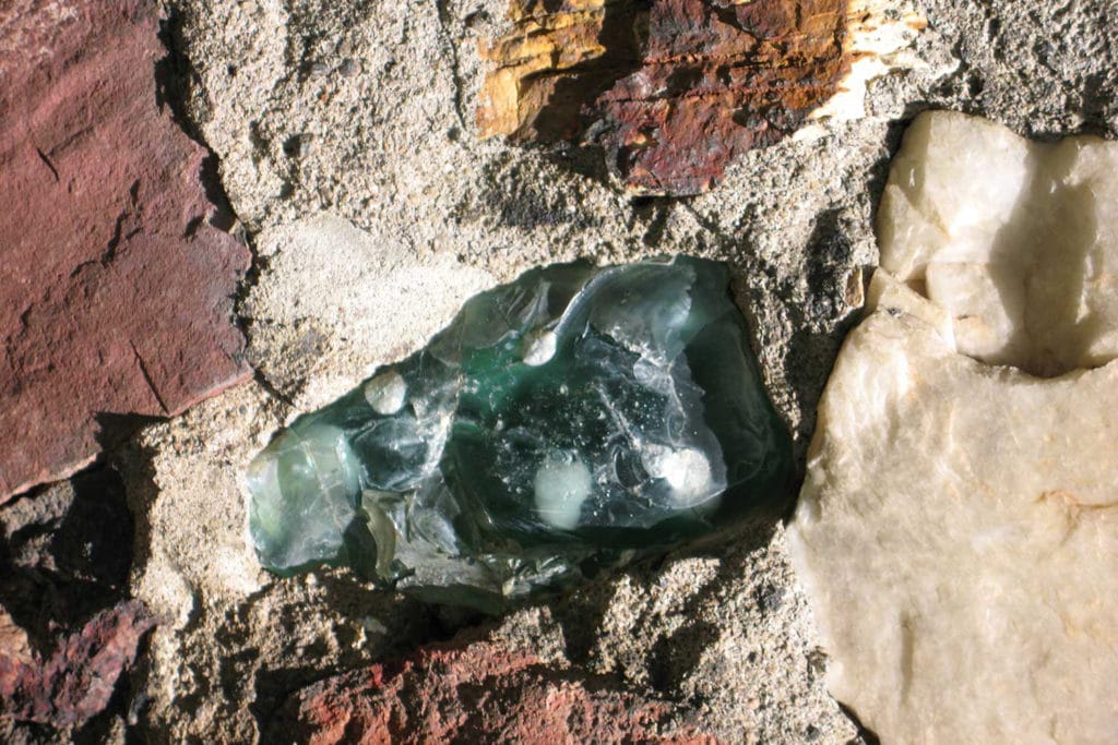 Detail of a colorful stone set into a building's wall