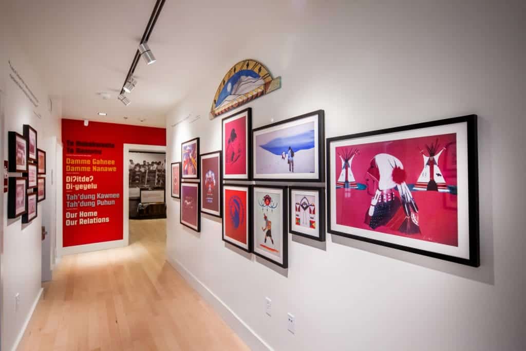 Contemporary work by Great Basin Native artists hangs on a white wall in a gallery