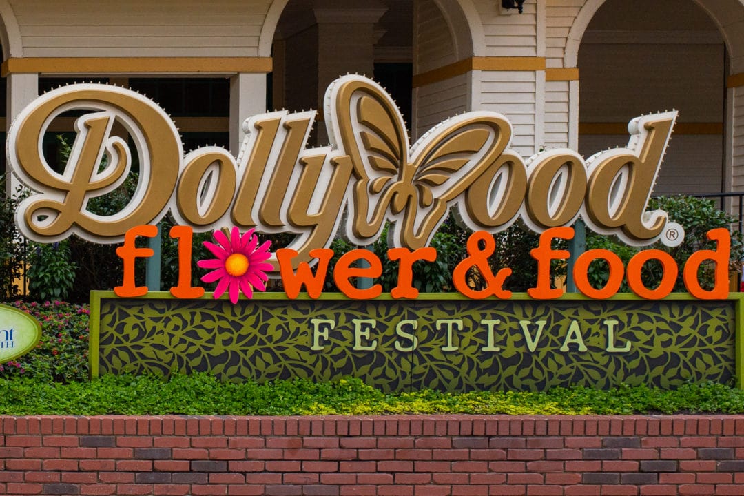 a gold sign that spells out "Dollywood flower and food festival"