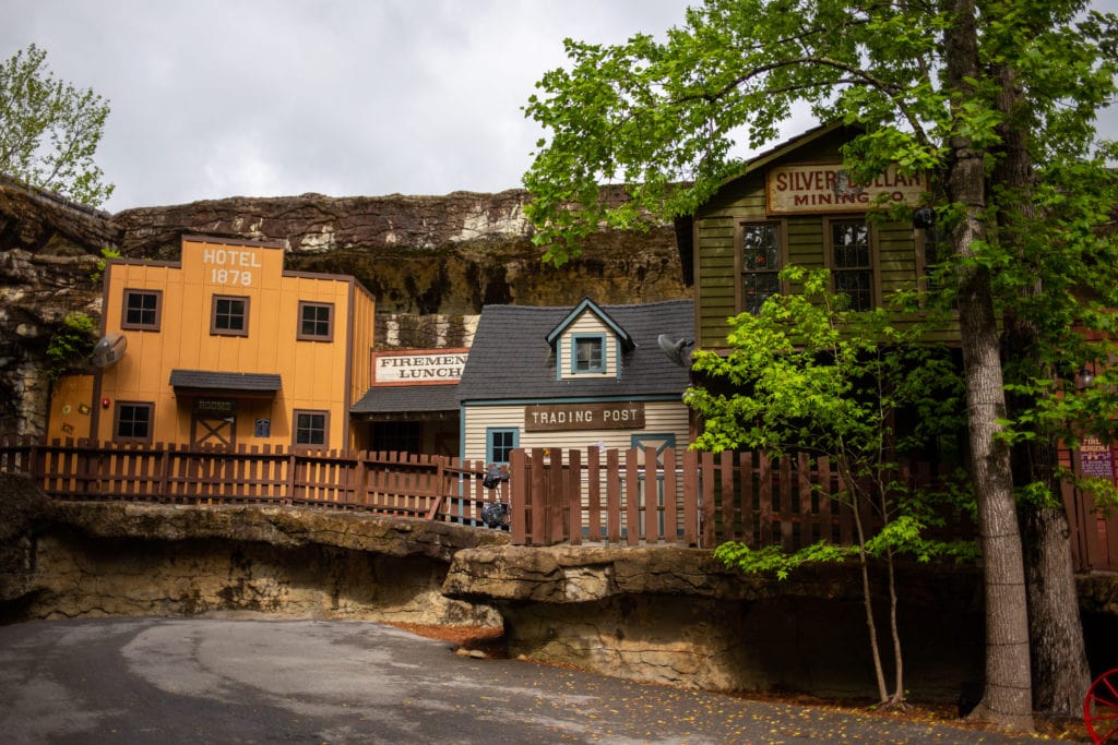 several buildings built to resemble an old timey town including a hotel and trading post