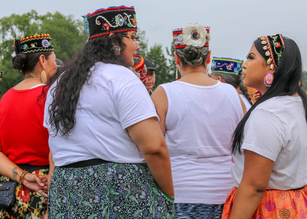 A group wearing embroidered hats and headbands.