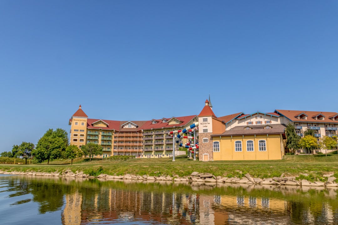 the exterior of the bavarian inn lodge near water set against a blue sky