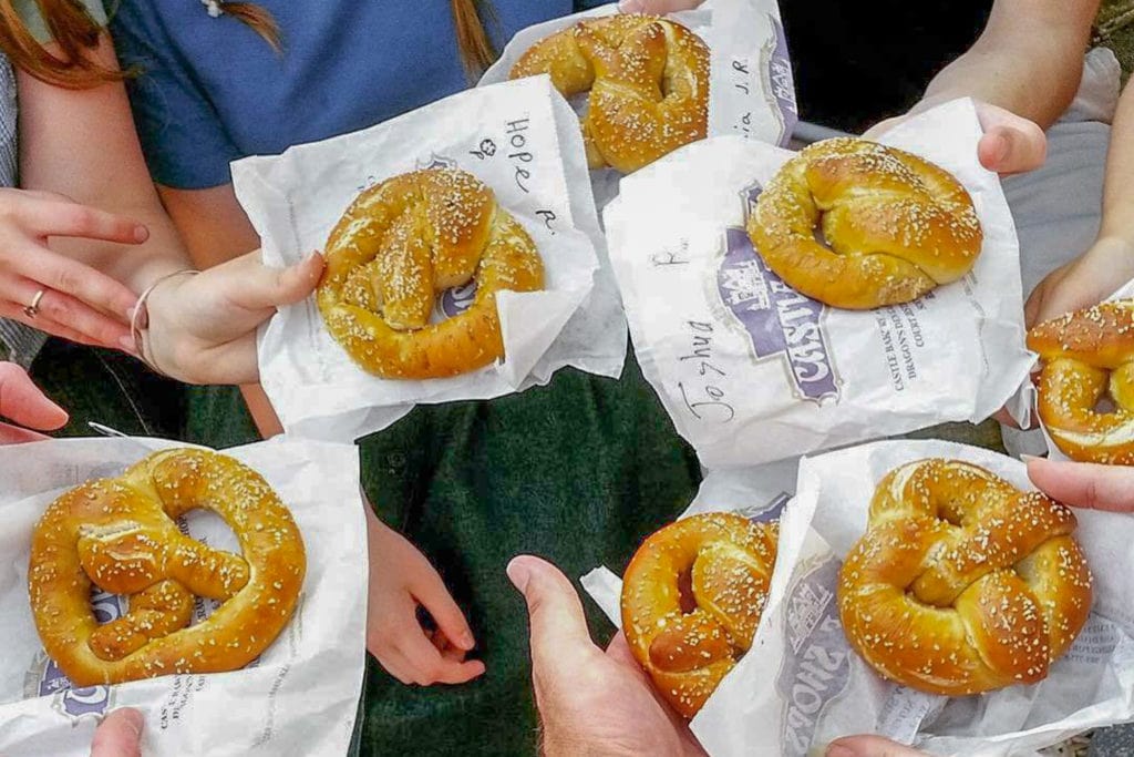 hands hold soft salted pretzels