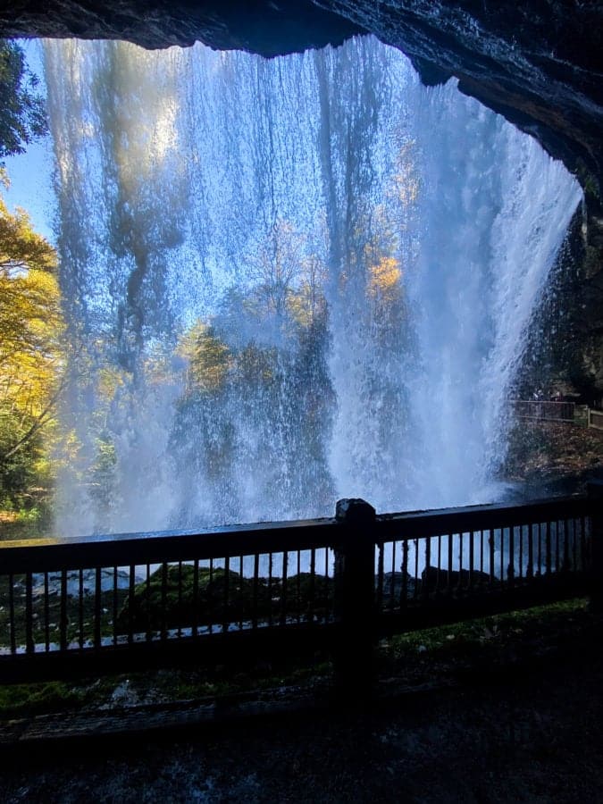 Rushing water from the backside of a waterfall