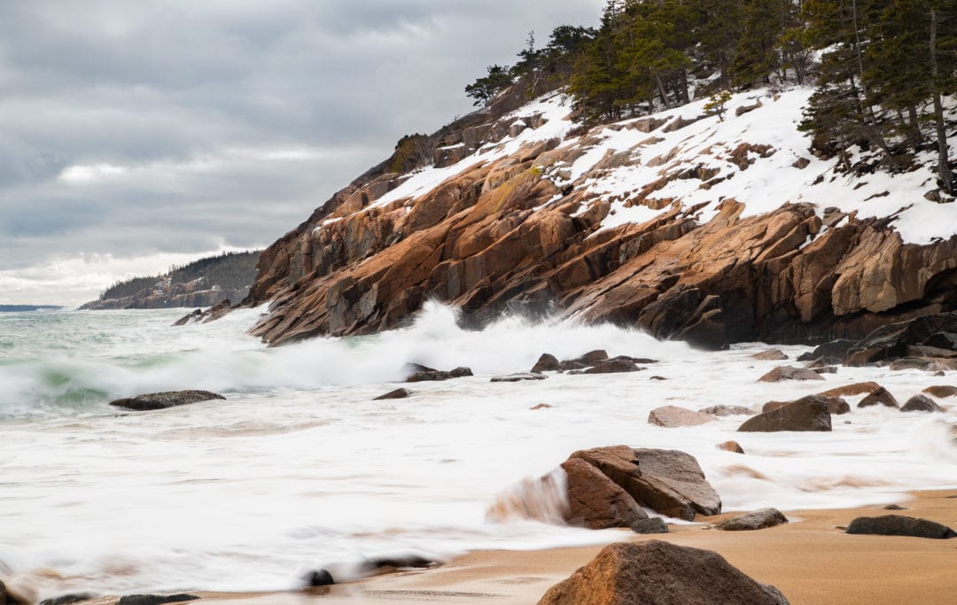 Sand beach with snow at Acadia National Park
