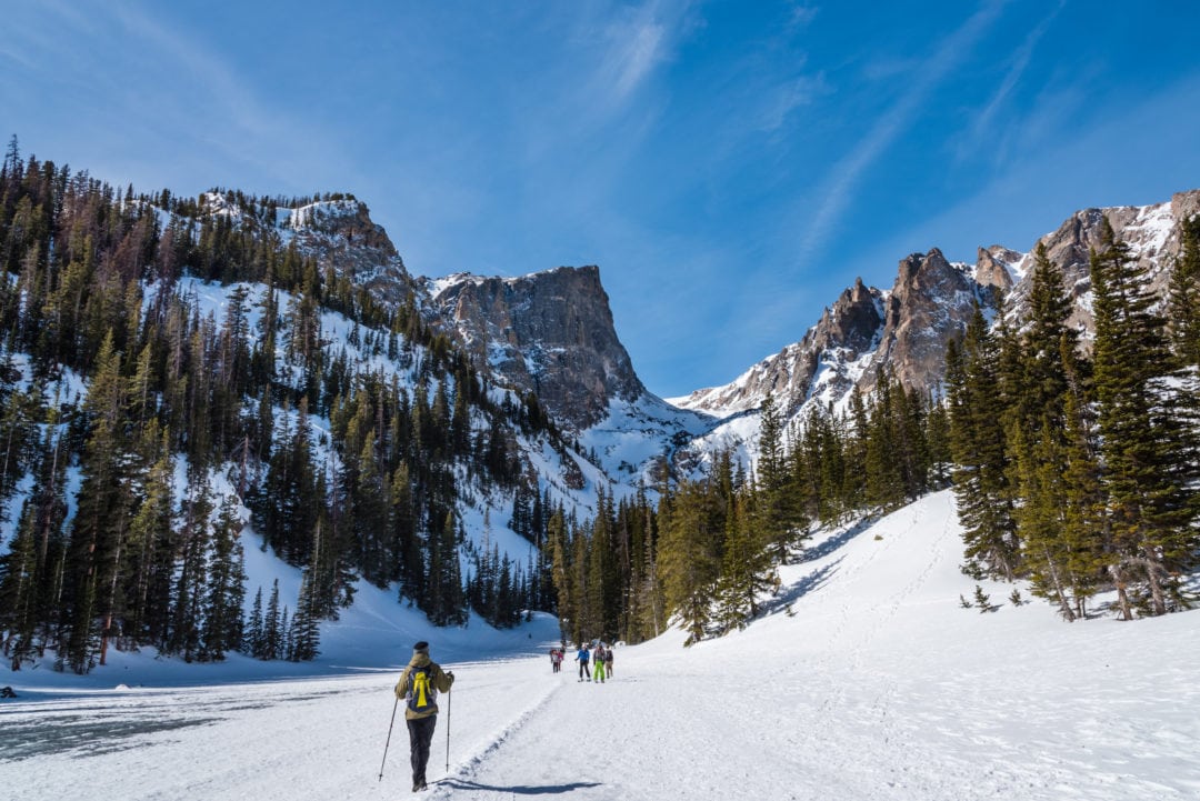 Hiking over a frozen lake at Rocky Mountain National Park.