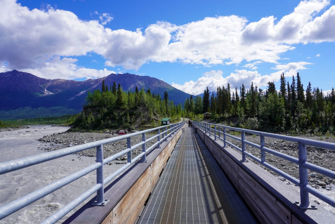 A narrow footbridge over a rushing river