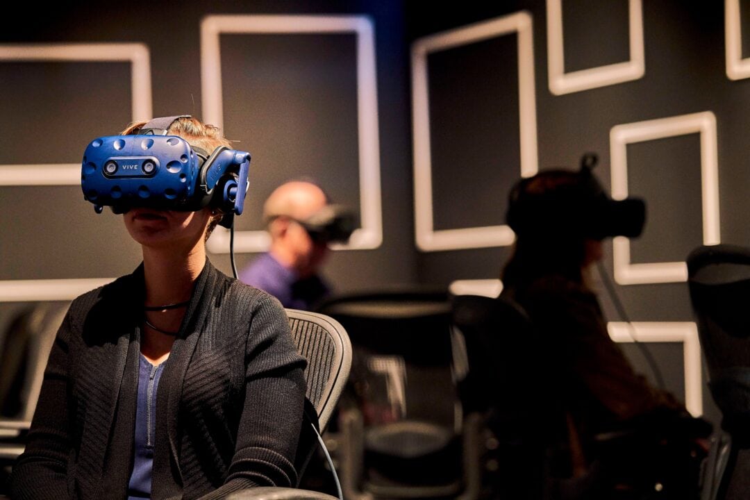 Museum visitors with VR headsets on watching the exhibit