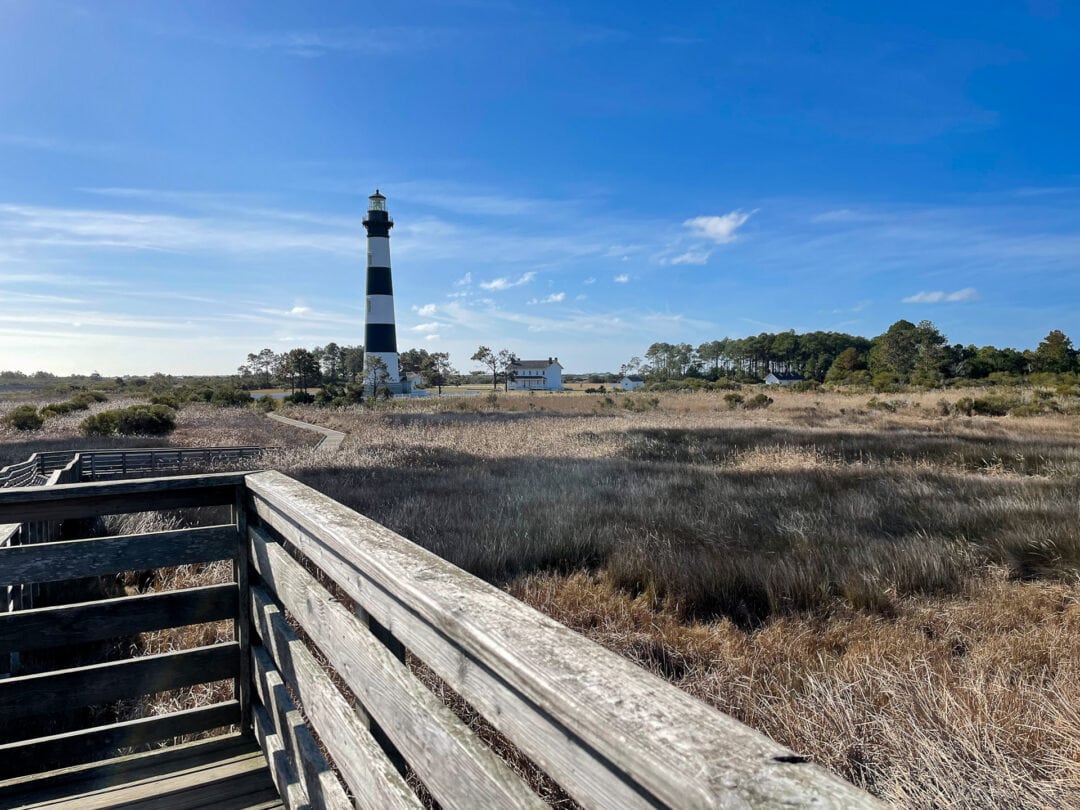 Lighthouse set amongst tall sand grass
