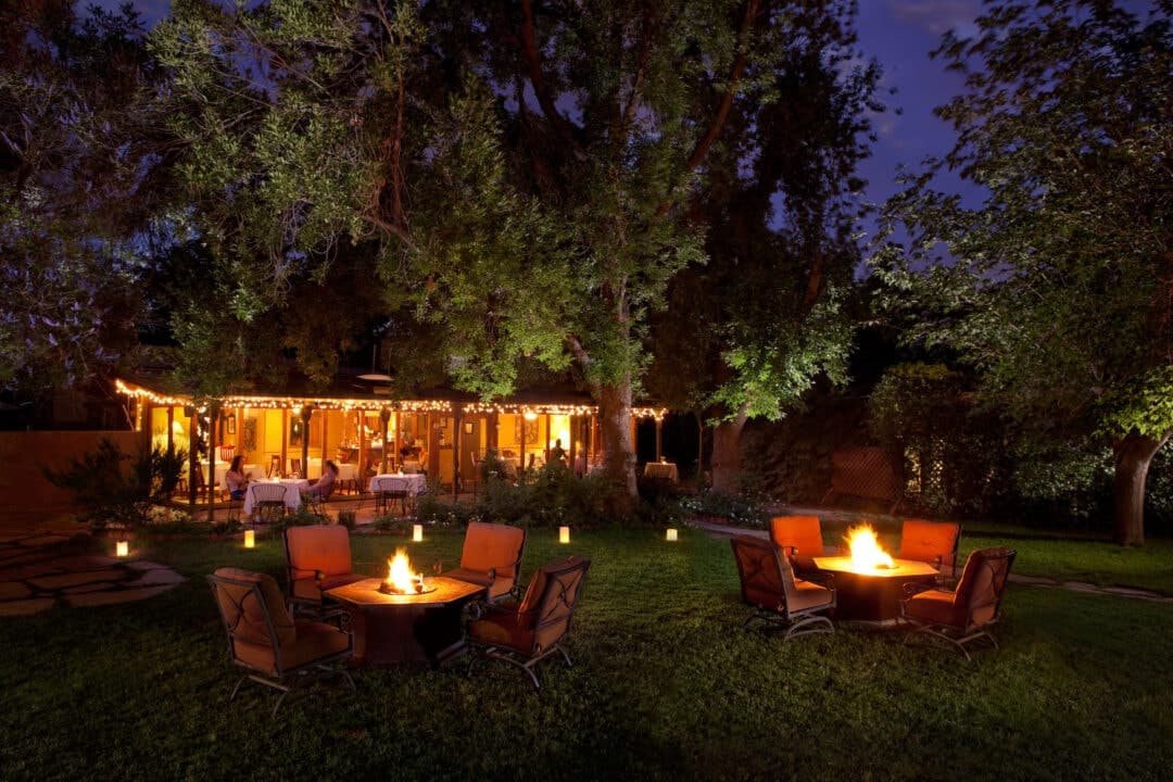 tables and a an outdoor restaurant at night