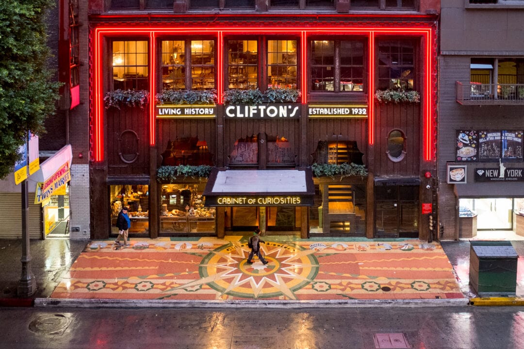 the exterior of the two-story clifton's with a sign that says living history clifton's established 1932