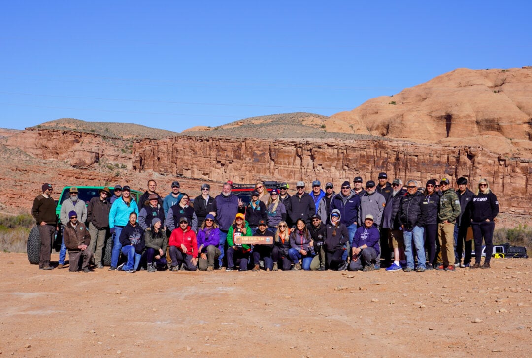 A group of 50 people lined up and posing for the camera
