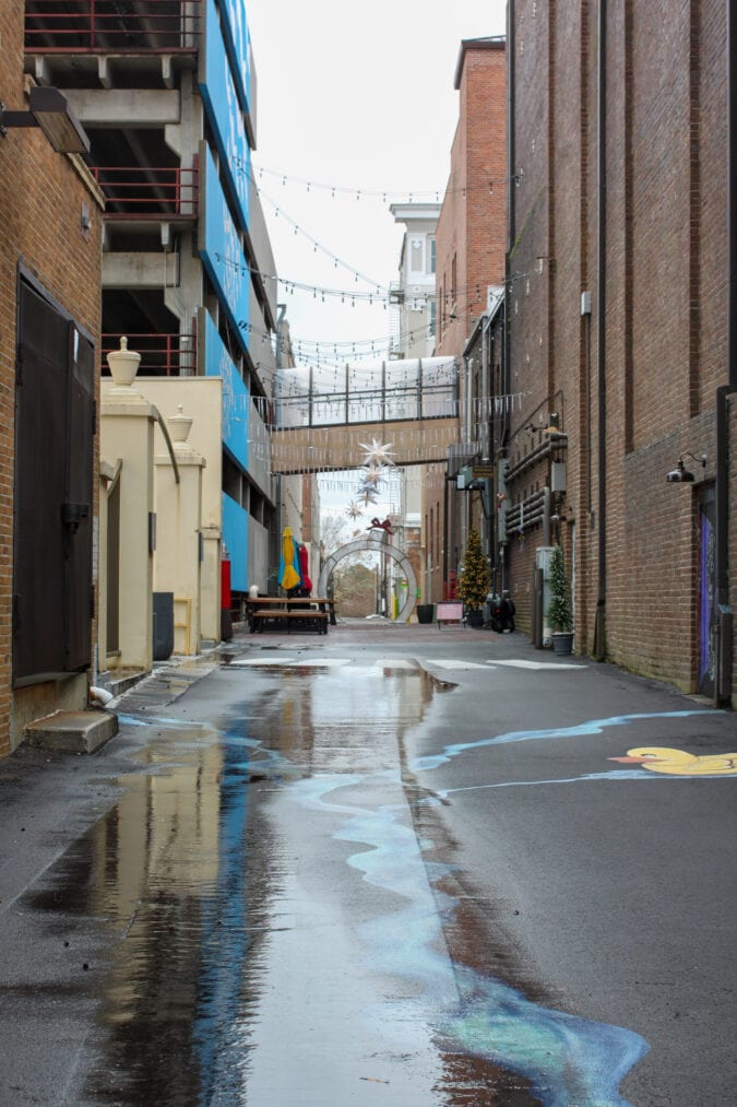 an alleyway in between several brick buildings