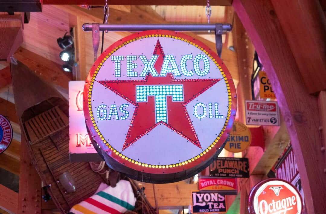 A lit round vintage Texaco neon sign