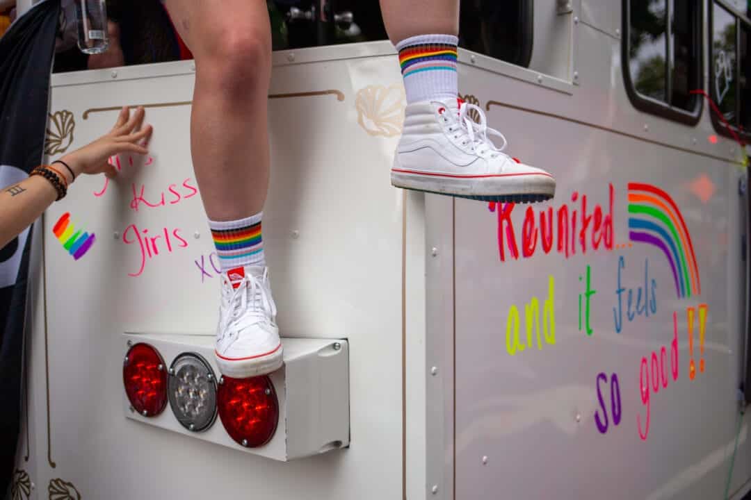 a pair of hightop clad legs dangles from a white trolley