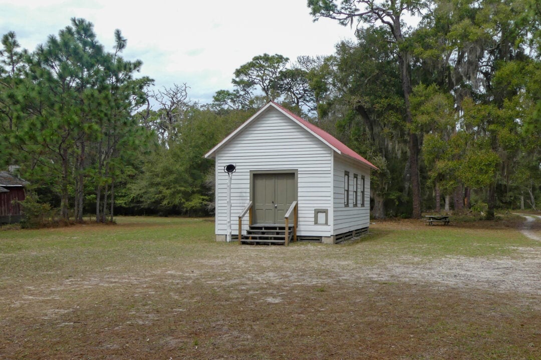 a small white church with a red roof