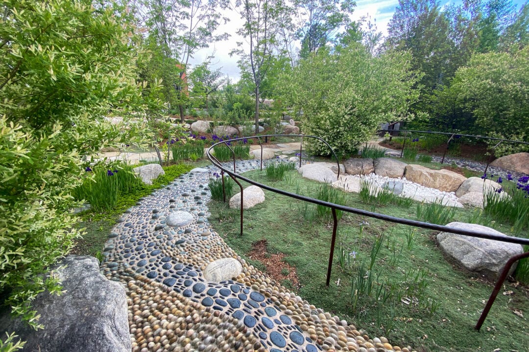 a stone path through a garden