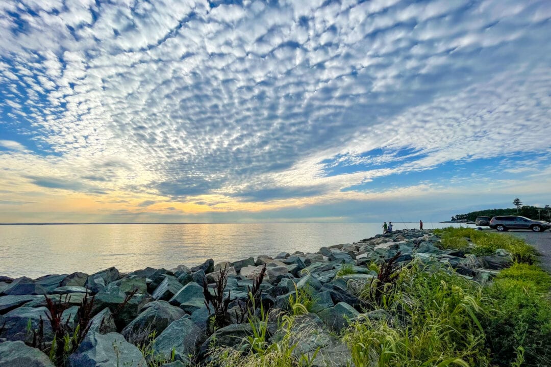 a rocky coastline under a dramatic sky of clouds