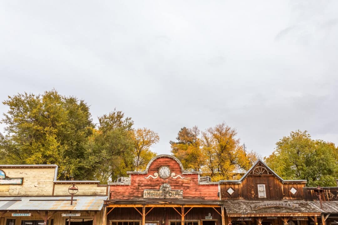 false old west fronts set along a backdrop of gold and green trees