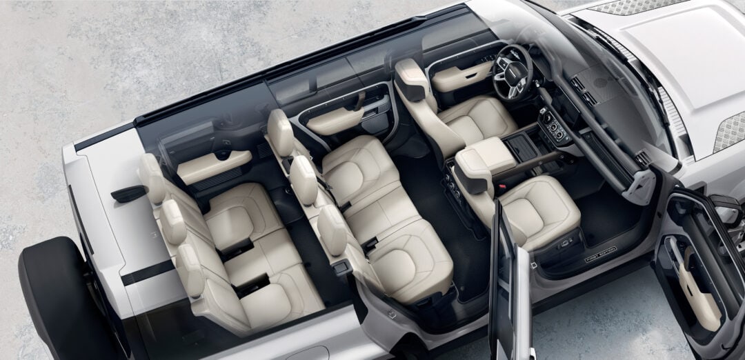 an aerial shot of a white land over with the top down and doors open