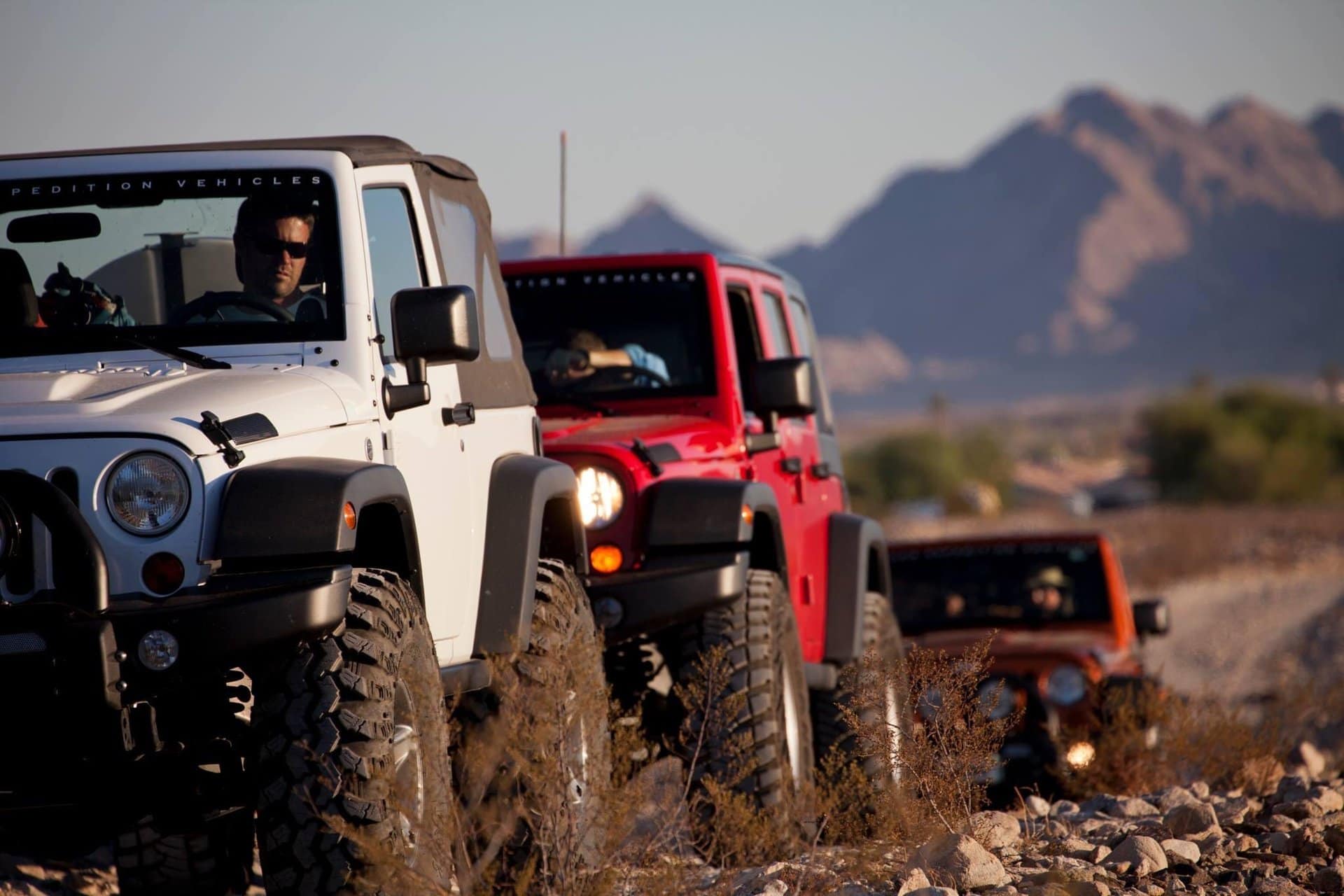 a line of jeeps in the desert