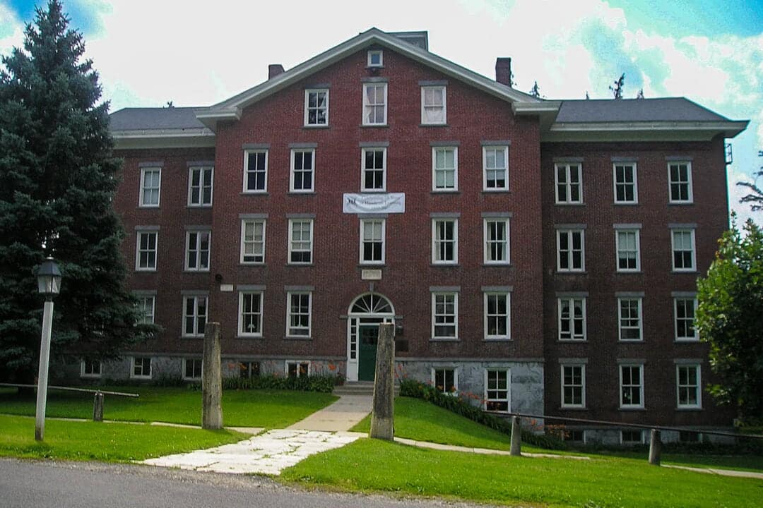 The Mount Lebanon Shaker Society is an imposing brick building that features a bounty of windows from each of its more than six stories
