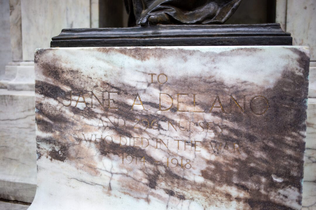 a stone base for a sculpture that says "to jane delano and 296 nurses who died in the war"