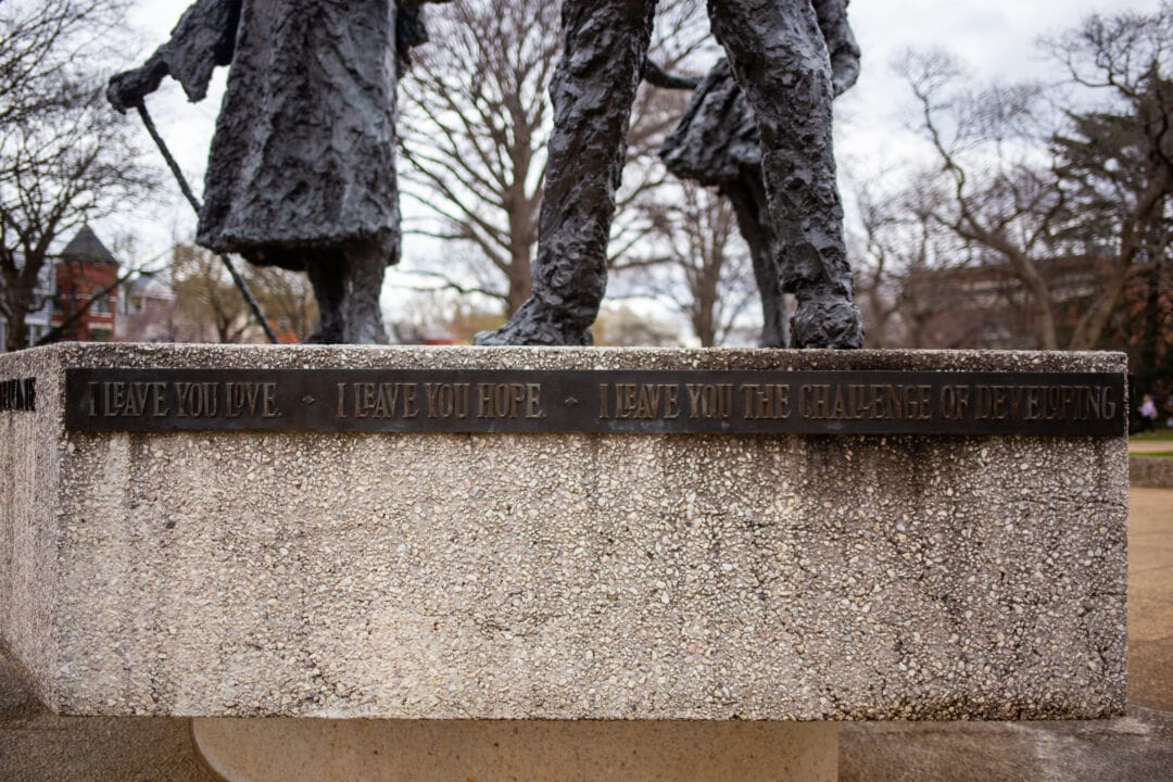 a closeup of the mary mcleod bethune bronze and stone statue featuring a quote "i leave you love. i leave you hope. i leave you with the challenge of developing..."