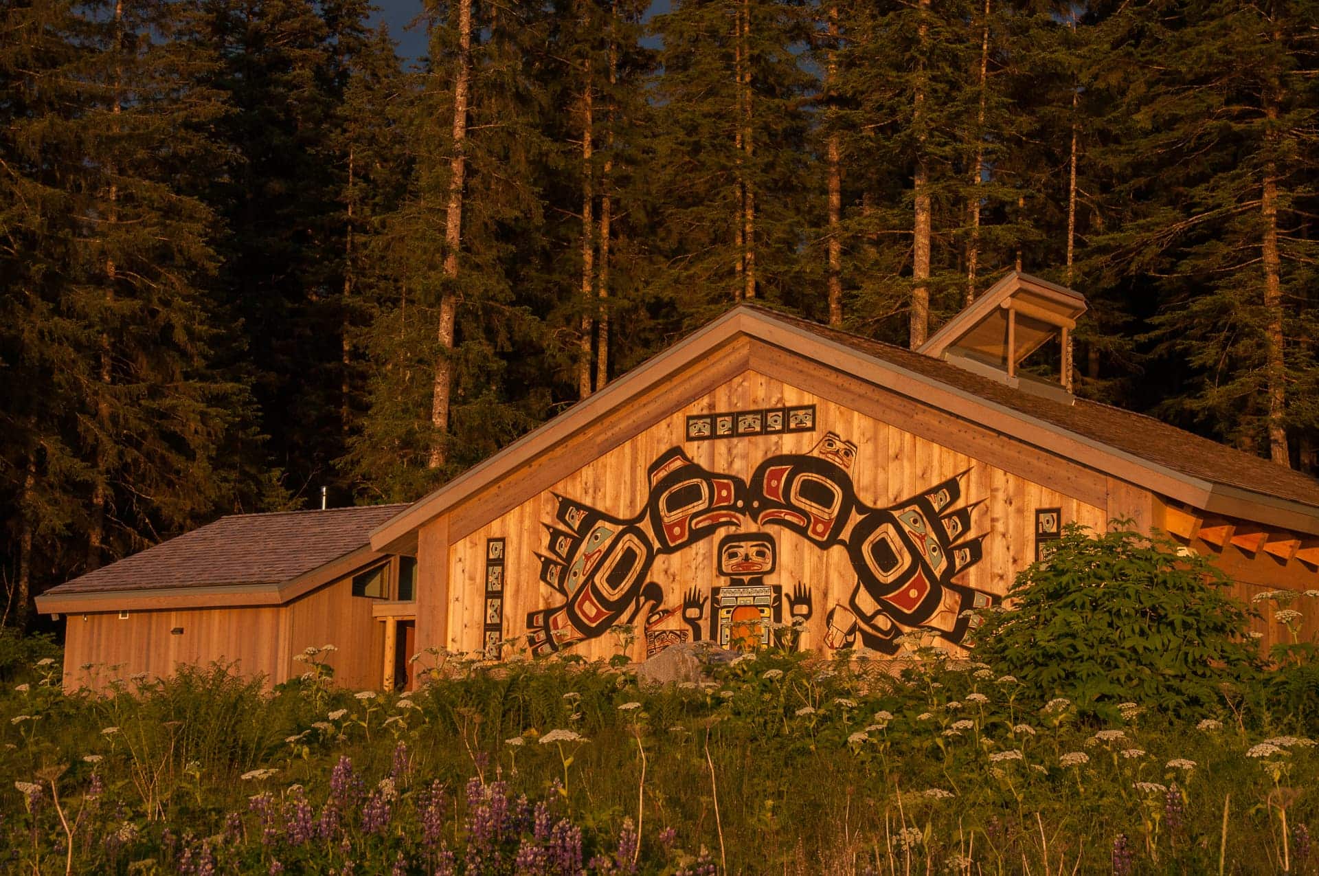 Tribal house at sunset in national park with Indigenous paintings on side